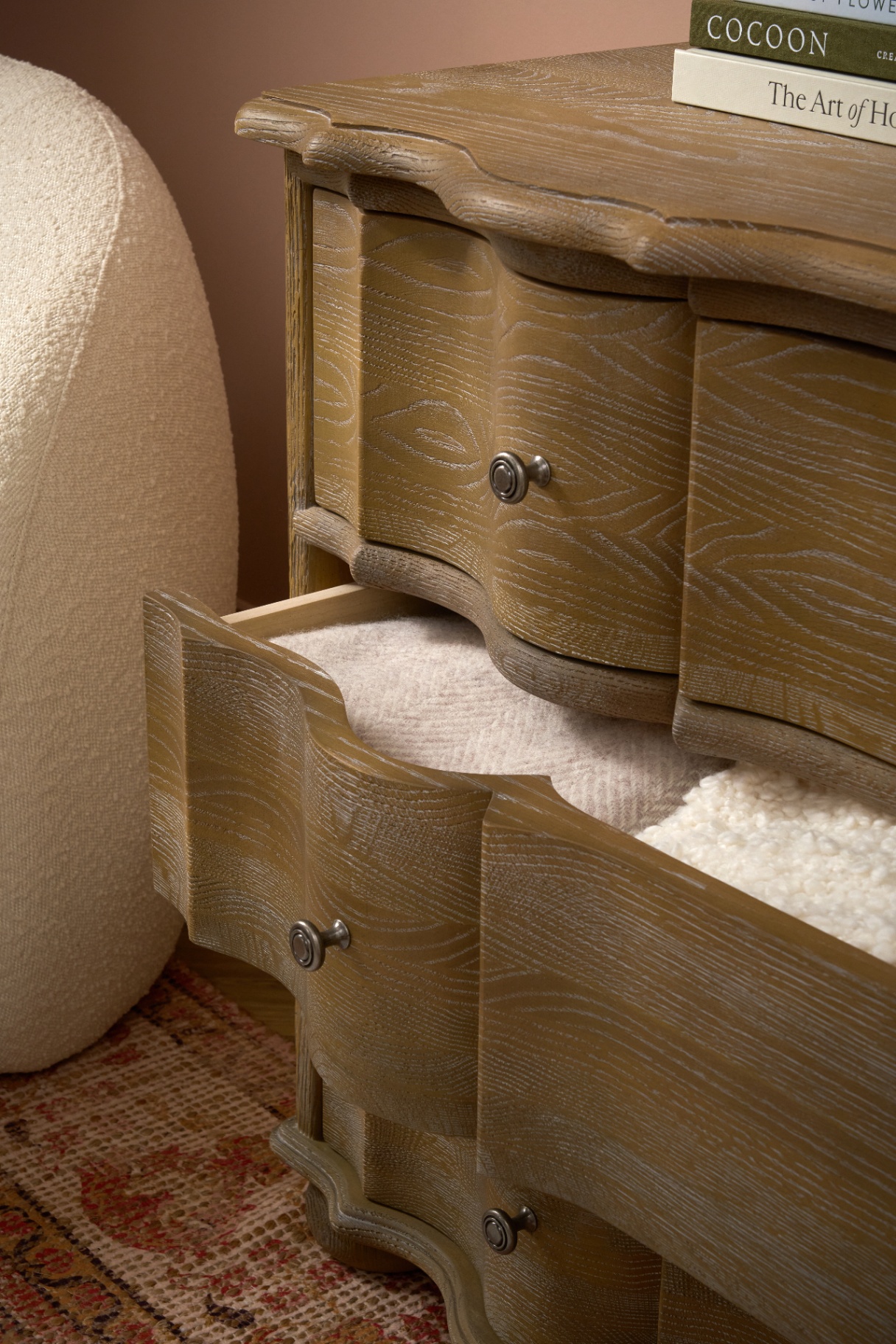 Scalloped oak drawer detail with brass handles